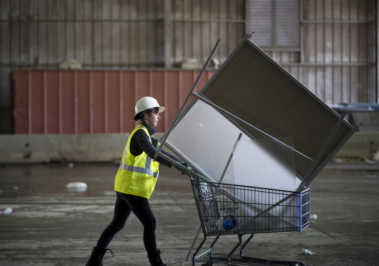 Recology Artist in Residence Yulia Pinkusevich scavenges for materials to use to create art at a San Francisco dump Oct.