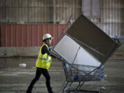 Recology Artist in Residence Yulia Pinkusevich scavenges for materials to use to create art at a San Francisco dump Oct.