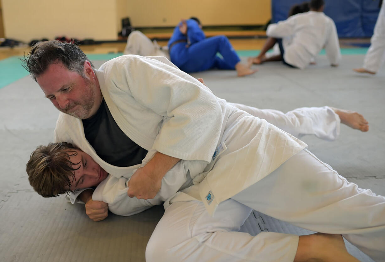 Author Des Bieler, top, tries to contain Nicholas Dudek as Bieler tries out judo for the first time at the Kennedy Recreation Center in Washington.