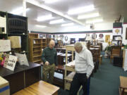 Vancouver Woodworks Furniture owner Bruce Lyons, left, helps customer Malcolm Storey of Vancouver look for bedroom furniture Oct.