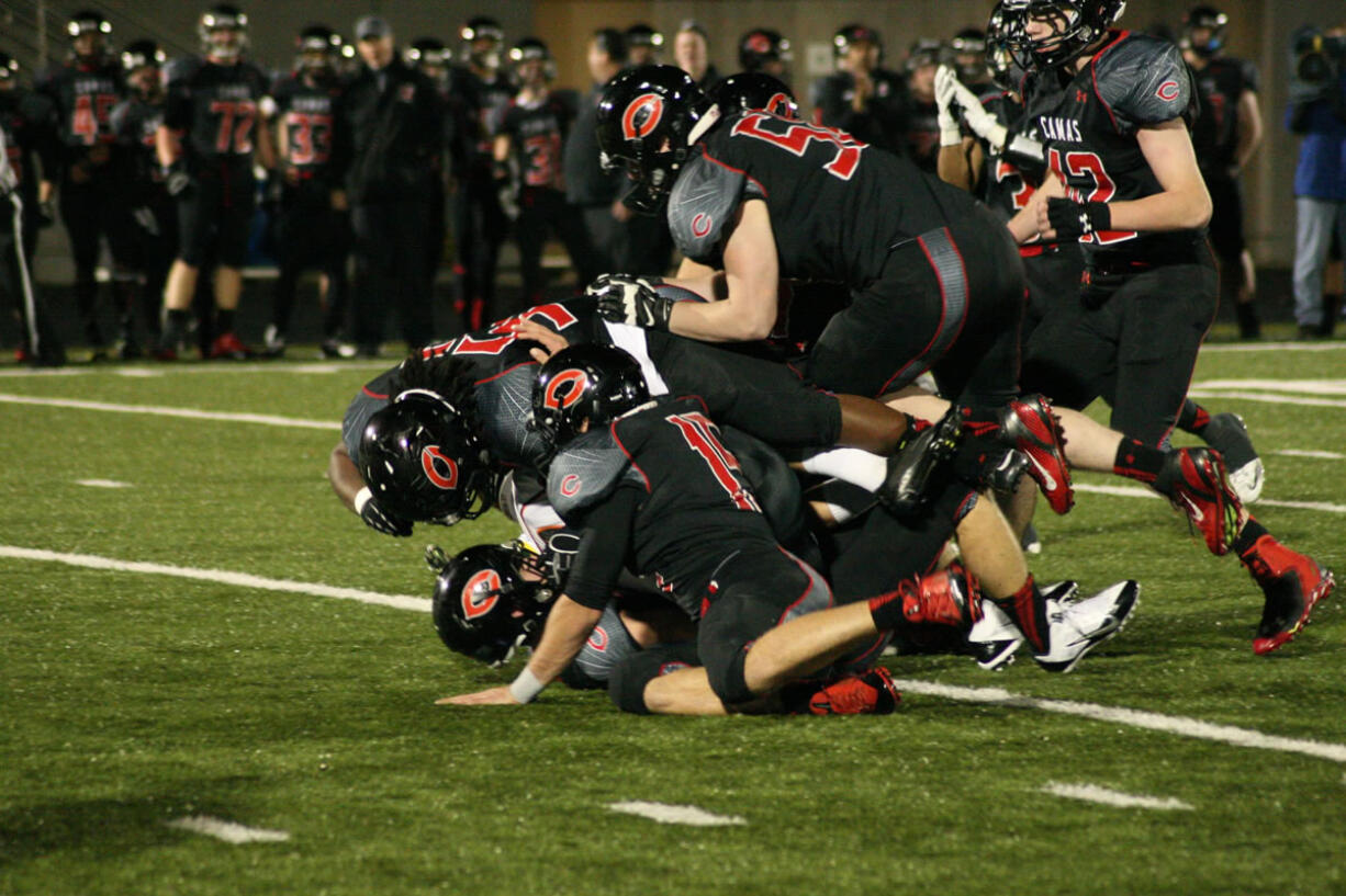 The Papermakers bury a Monroe Bearcat on Doc Harris Stadium turf Friday.