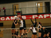 Lauren Harris and Sophi Jacobson  double up on the Union Titans at the volleyball net Wednesday, at   Camas High School.