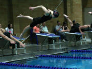 Juliann Reed dives into the swimming pool during the 4A district meet Saturday, at Kelso High School.