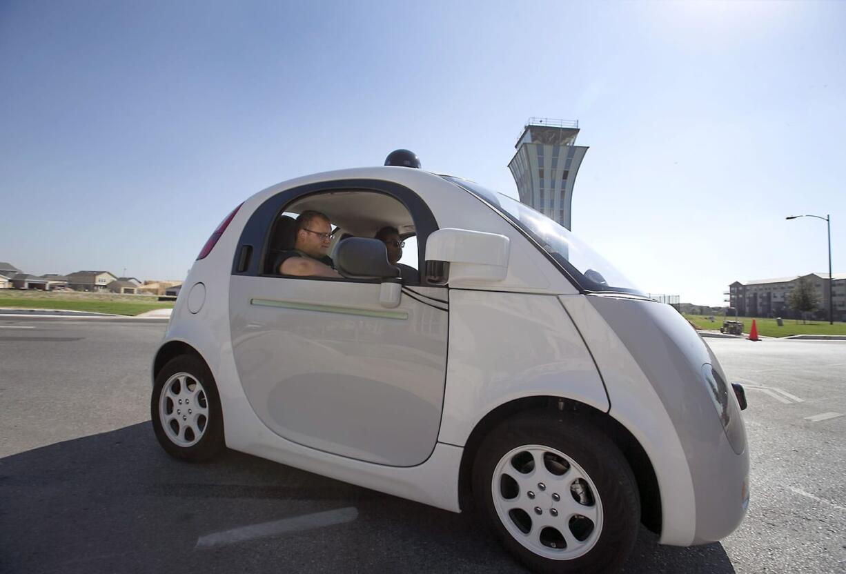 Google's self-driving car tours the Mueller Housing Development, Wednesday, Sept. 23, 2015, in Austin, Texas. Hustling to bring cars that drive themselves to a road near you, Google finds itself somewhere that has frustrated many before: Waiting for help from California's department of motor vehicles.