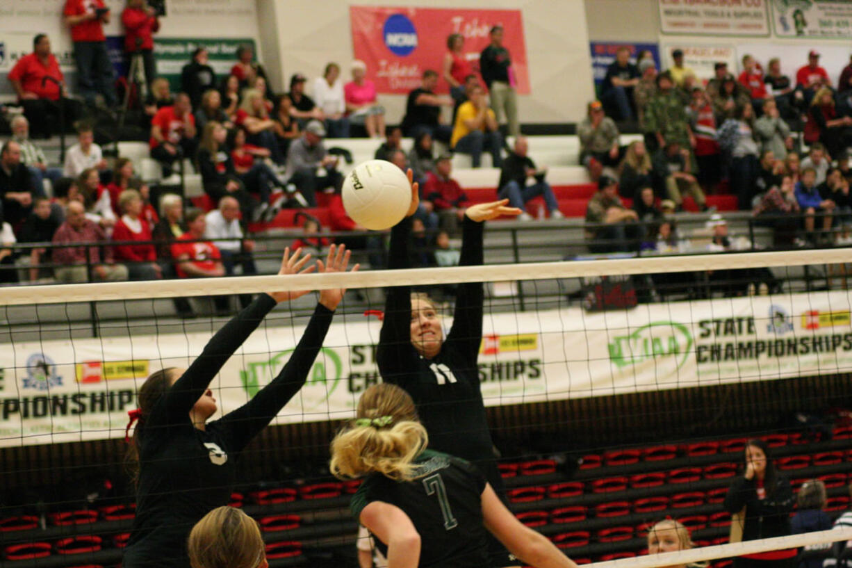 Lauren Harris and Carly Banks attack the volleyball for Camas during the state tournament Friday, at St. Martin's University.