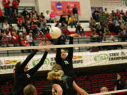 Lauren Harris and Carly Banks attack the volleyball for Camas during the state tournament Friday, at St. Martin's University.