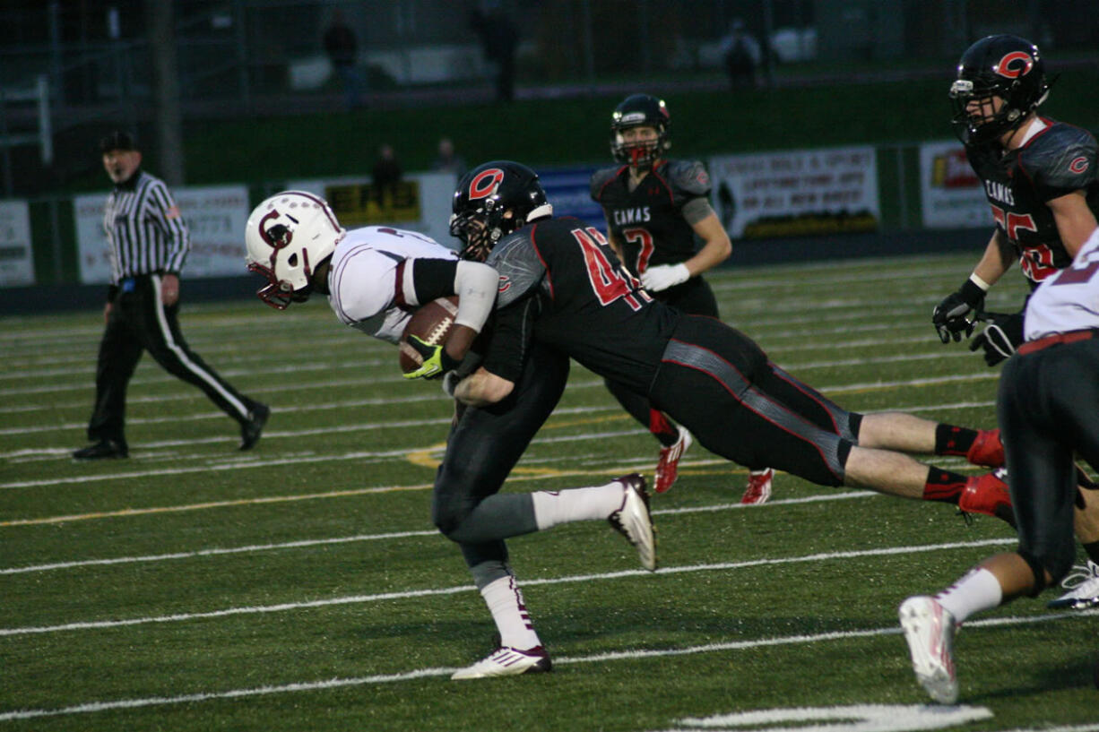 Camas High School junior linebacker Gabe Lopes lassos the Cascade quarterback Saturday, at Doc Harris Stadium.