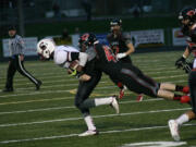 Camas High School junior linebacker Gabe Lopes lassos the Cascade quarterback Saturday, at Doc Harris Stadium.