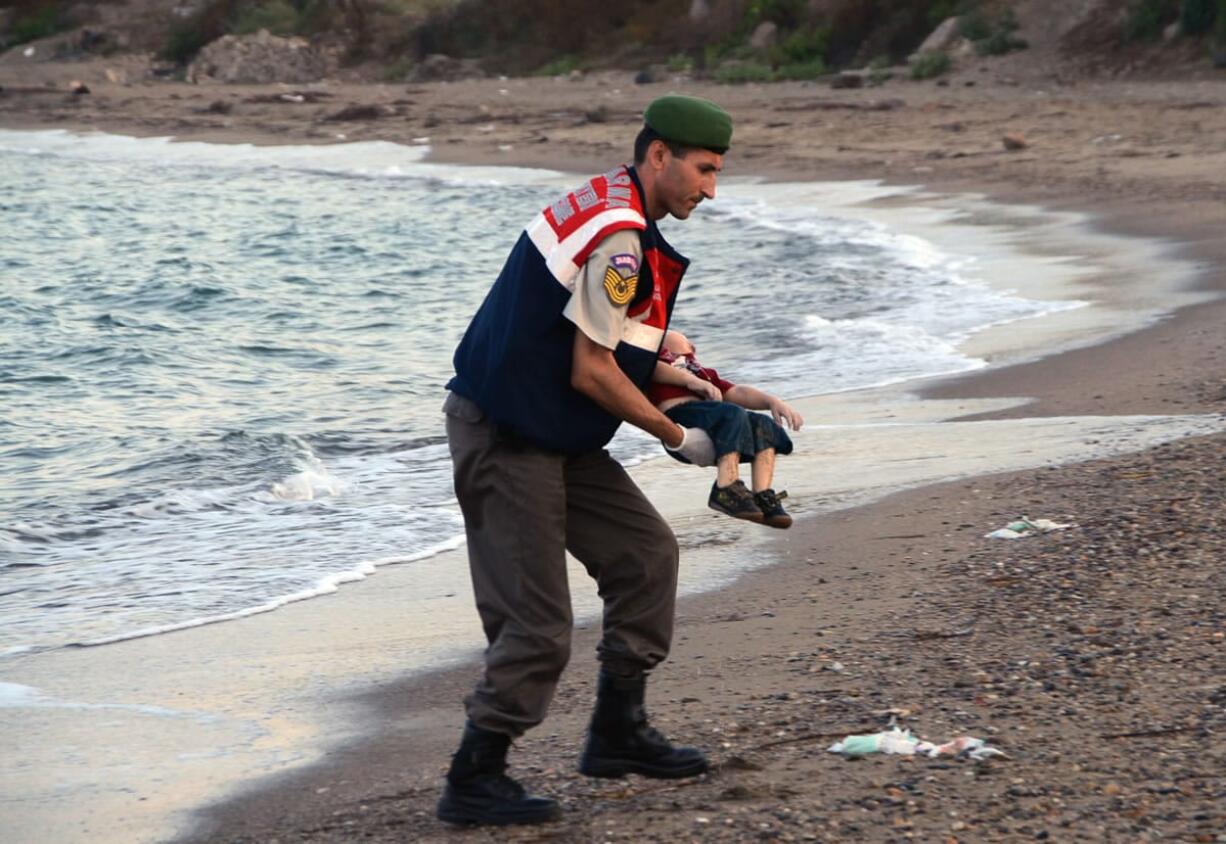 A paramilitary police officer carries the body of Aylan Kurdi, 3, on Sept. 2 after a number of migrants died when their boats capsized near the Turkish resort of Bodrum.