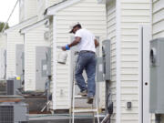 Painter Carlos Alvaro touches up the exterior of a townhome in Morrisville, N.C.