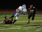 La Center High School's Conner Fulton attempts to break free with Mount Baker's Joey Walton closing in during the state football quarterfinals, Saturday, Nov. 23, 2013, at Civic Field in Bellingham.