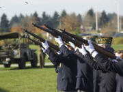 Shell casings fly as a Veterans of Foreign Wars detail fires a rifle salute during Monday's Veterans Day Celebration at the Armed Forces Reserve Center in east Vancouver.