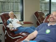 Jim Boline, left, and his son Joel donated blood at the same time at the American Red Cross Donor Center, near Vancouver Mall.