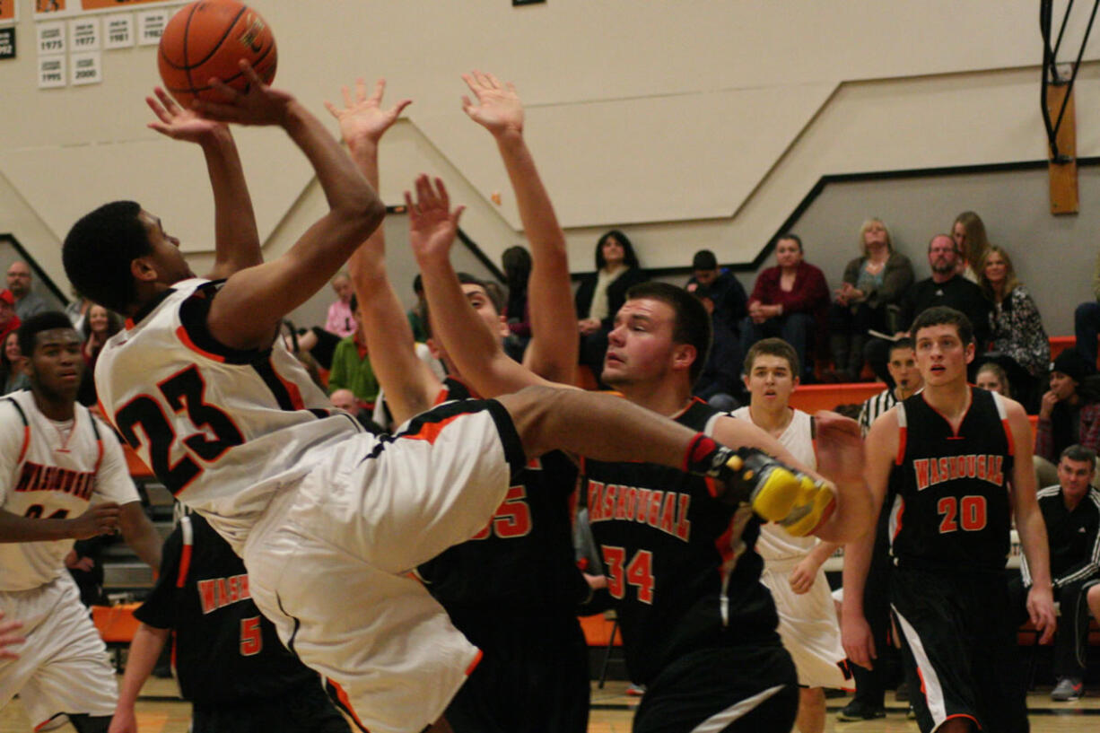 Yorro Bah hangs in there to score a basket during a scrimmage game at Washougal High School. The Panthers start the season at Battle Ground Friday.