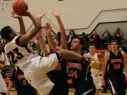 Yorro Bah hangs in there to score a basket during a scrimmage game at Washougal High School. The Panthers start the season at Battle Ground Friday.