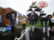 David Long, center, speaks on the basketball court dedicated Tuesday in memory of his daughter-in-law, Tiffany Long, pictured at top. She was a classroom aide at the 49th Street Academy and was working to become a special-education teacher.