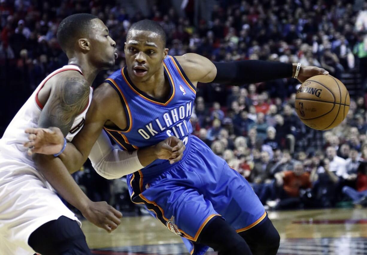 Oklahoma City Thunder guard Russell Westbrook, right, drives on Portland Trail Blazers guard Damian Lillard during the first half of a game on Dec.