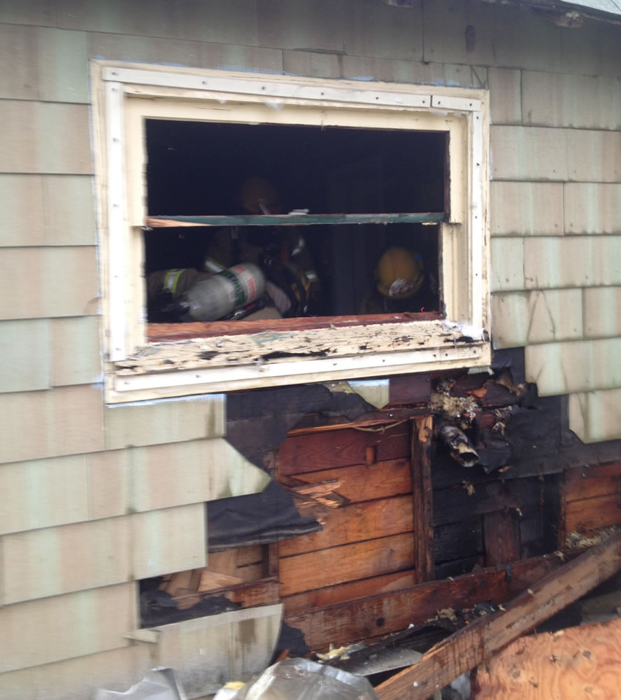 Clark County Fire &amp; Rescue firefighters douse a blaze started by a heat lamp used to thaw frozen pipes.