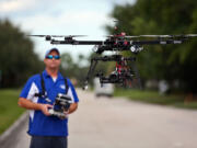 ReadyHeli.com technician and sales agent Brett Strand operates his own personal octacopter drone in Jupiter, Fla.,