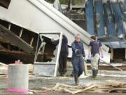 Officials work at the scene in the aftermath of a fire at the former Desire Video in 2003.