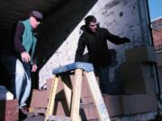 Walk &amp; Knock volunteers Toby Elliot, left, and Thomas Gilsrud load up boxes of donated food Dec.