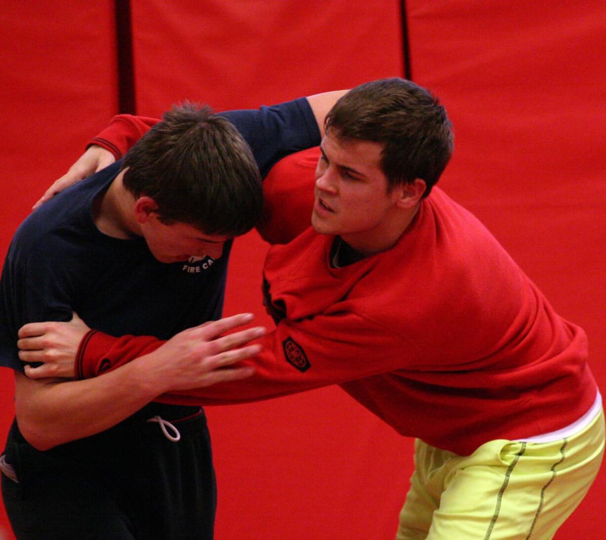 Camas High School seniors Tye Lommasson (left) and Marcus Hartman (right) tangle in the Papermaker wrestling room.