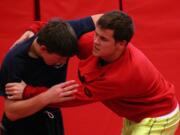 Camas High School seniors Tye Lommasson (left) and Marcus Hartman (right) tangle in the Papermaker wrestling room.