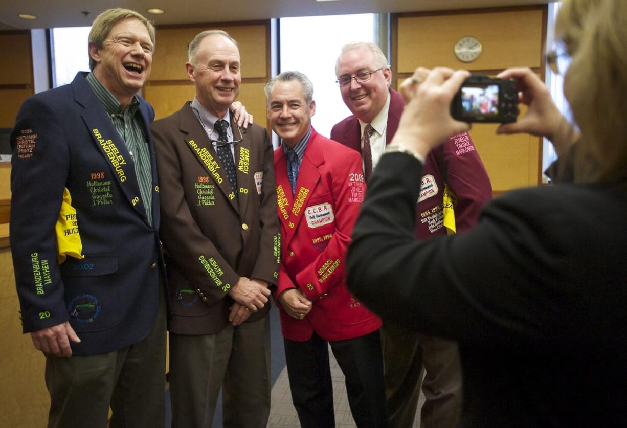 Judicial assistant Jennifer Wolfe photographs Team Dynasty in their uniquely decorated victory jackets from the Clark County Bar Association golf tournament.