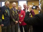 Judicial assistant Jennifer Wolfe photographs Team Dynasty in their uniquely decorated victory jackets from the Clark County Bar Association golf tournament.