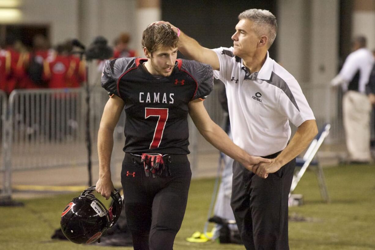 Coach Jon Eagle greet Nate Beasley as he comes off the field during Papermakers' win overBellarmine Prep in the Class 4A state semifinal football game in Tacoma.