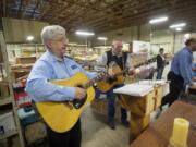 The Rev. Duane Sich, left, founder and longtime leader of homeless ministry Friends of the Carpenter, leads a musical prayer service on his 12-string guitar.