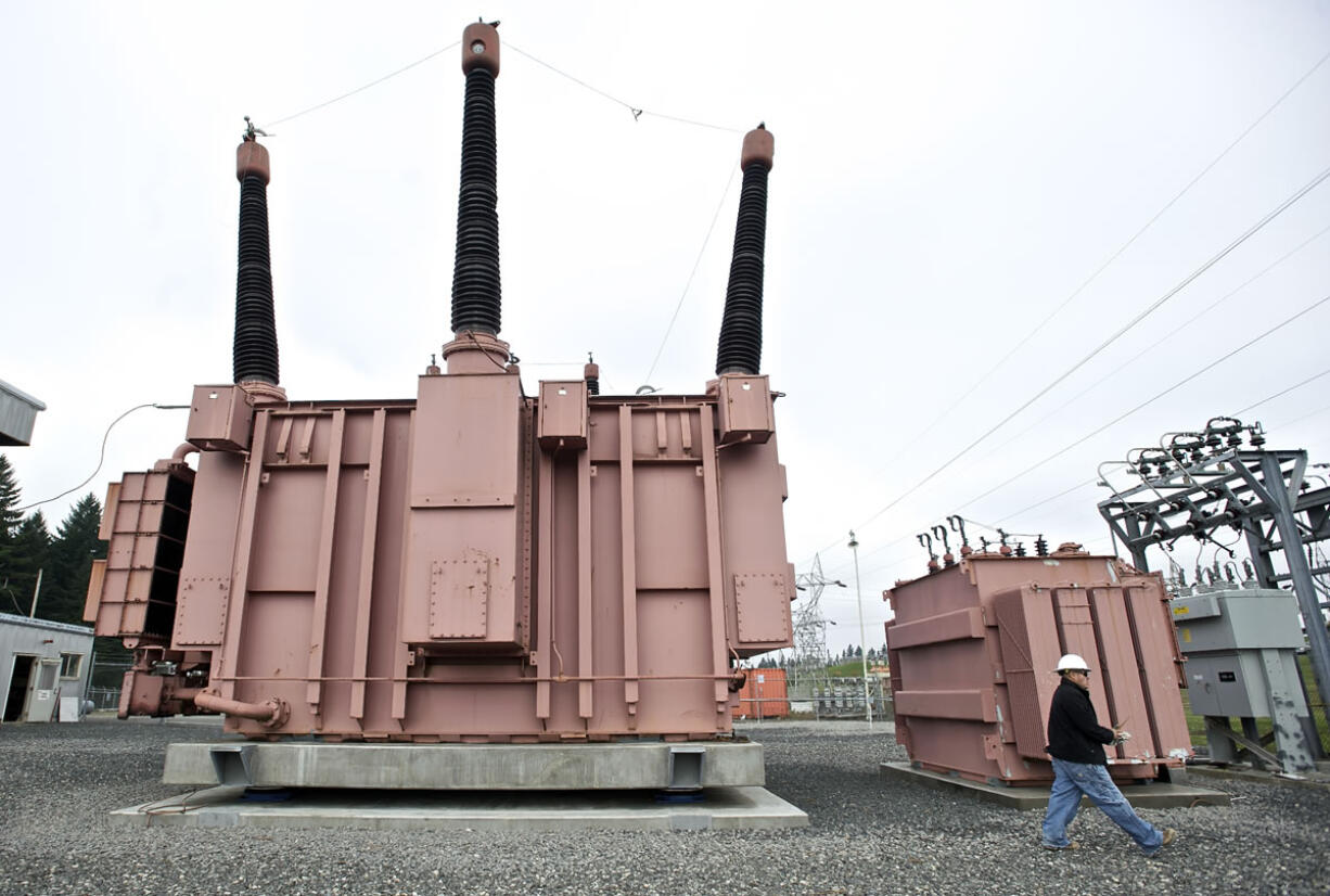 Bonneville Power Administration civil engineering technician David Robledo walks past a test transformer at Vancouver's Ross Complex substation.