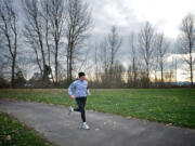 A man runs Thursday along the waterfront where the Waterfront Renaissance Trail and Frenchman's Bar Trail meet in Vancouver.