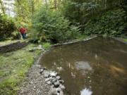 David Rogers shows a neighbors pond that had silted in after blasting started at the Yacolt Mountain Quarry in 2011.