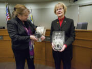 Vancouver City Councilors Jeanne Harris, left, and Jeanne Stewart admire engraved vases presented to them Monday at a meeting at City Hall.