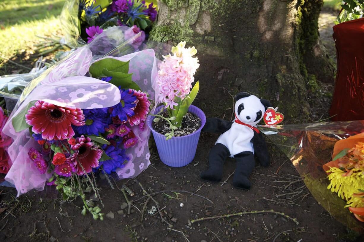 Flowers and gifts were left Monday by a group of people who stopped to pay their respects at the site of a Sunday hit-and-run crash that killed two at the intersection of 72nd and Van Mall Drive in Vancouver.