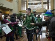 Timbers&#039; team captain Liam Ridgewell, center, greets a crowd of fans after arriving at the Business Aviation Terminal in Portland with teammates Monday morning, Nov. 30, 2015. The team was celebrating after winning the Major League Soccer Western Conference Championship.