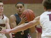 Tre Eisenhut (3) of Fort Vancouver drives to the basket against defenders Palmer Goecke (2) and James Phillips (11) of Prairie in a game Tuesday.