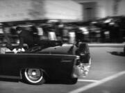 The limousine carrying President John F. Kennedy races toward the hospital seconds after he was shot in Dallas on Nov. 22, 1963. Secret Service agent Clint Hill is riding on the back of the car. As Nellie Connally, wife of Texas Gov.