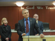 Councilor David Madore, center, joins fellow Clark County Councilors Jeanne Stewart, left, and Tom Mielke on Tuesday morning for a proclamation announcing the placement of "In God We Trust" in the county hearing chambers.