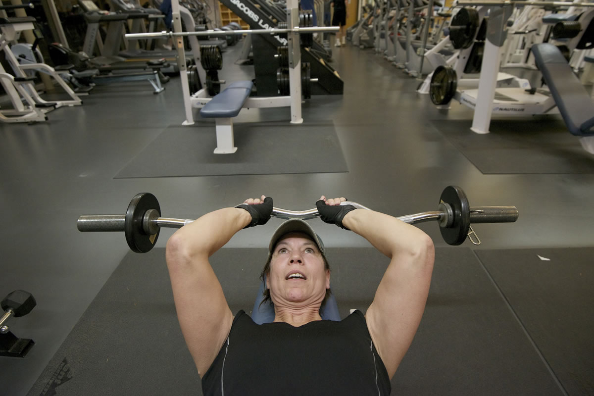 Teresa Huddleston of Vancouver lifts weights at the Marshall Center on Monday. Huddleston has been going to the Marshall Center for four years and works out four times a week. As a city resident, she'll soon pay a few dollars less each month while noncity residents will pay a few dollars more.