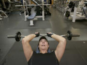 Teresa Huddleston of Vancouver lifts weights at the Marshall Center on Monday. Huddleston has been going to the Marshall Center for four years and works out four times a week. As a city resident, she'll soon pay a few dollars less each month while noncity residents will pay a few dollars more.