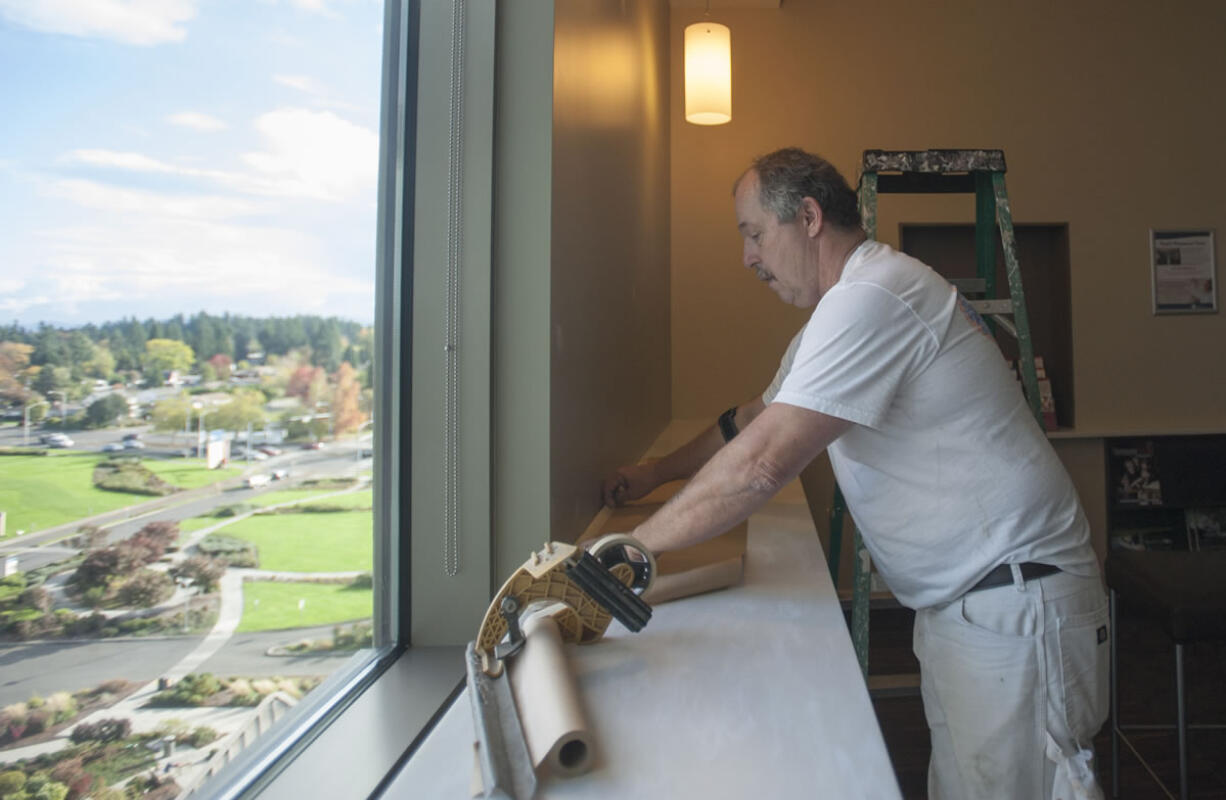 Painter Bill Goen puts the finishing touches on a room in PeaceHealth Southwest Medical Center&#039;s new neurosciences inpatient unit Monday afternoon. The hospital is officially opening the unit with a blessing ceremony today and will begin admitting patients later this week.