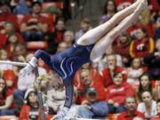 Brigham Young's KayCee Gassaway performs on the bars during a meet Jan.