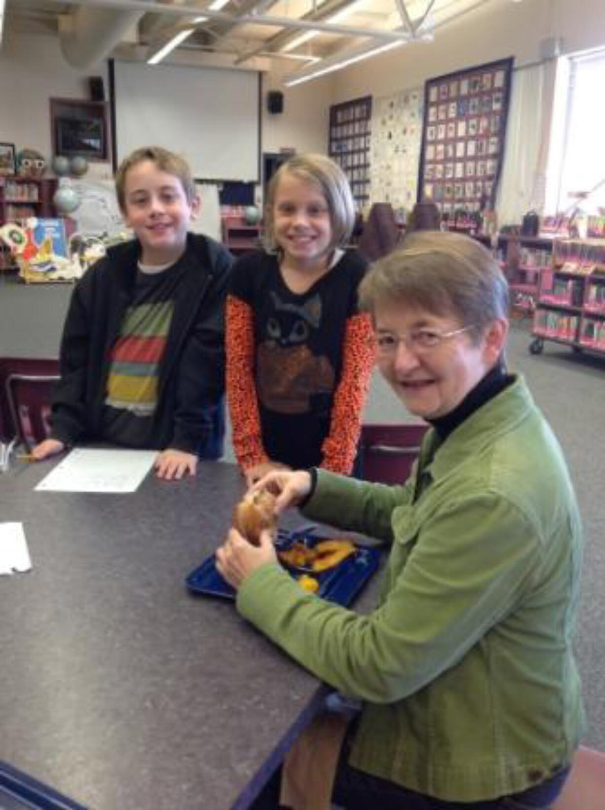 Vancouver Heights: Sled dog musher and author Pam Flowers visits with Teagan Schriber, left, and Katie Postma on Oct.