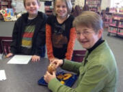 Vancouver Heights: Sled dog musher and author Pam Flowers visits with Teagan Schriber, left, and Katie Postma on Oct.