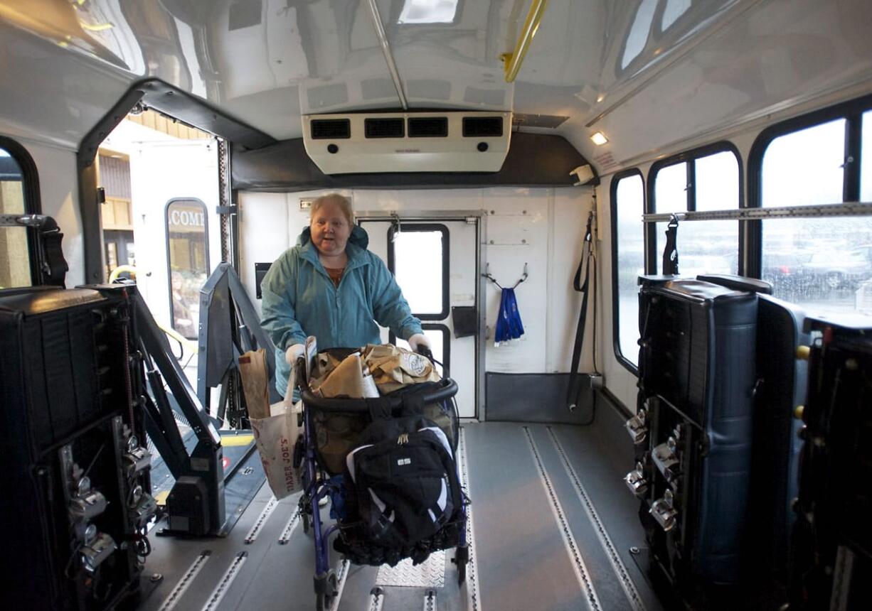 Vancouver resident Barbara Chu boards a C-Van vehicle after buying groceries at Chuck's Produce on Thursday.