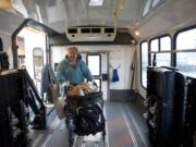 Vancouver resident Barbara Chu boards a C-Van vehicle after buying groceries at Chuck's Produce on Thursday.