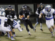 Hockinson running back Steven Carlisle (center) runs ball against Liberty in the first round of the state playoffs.