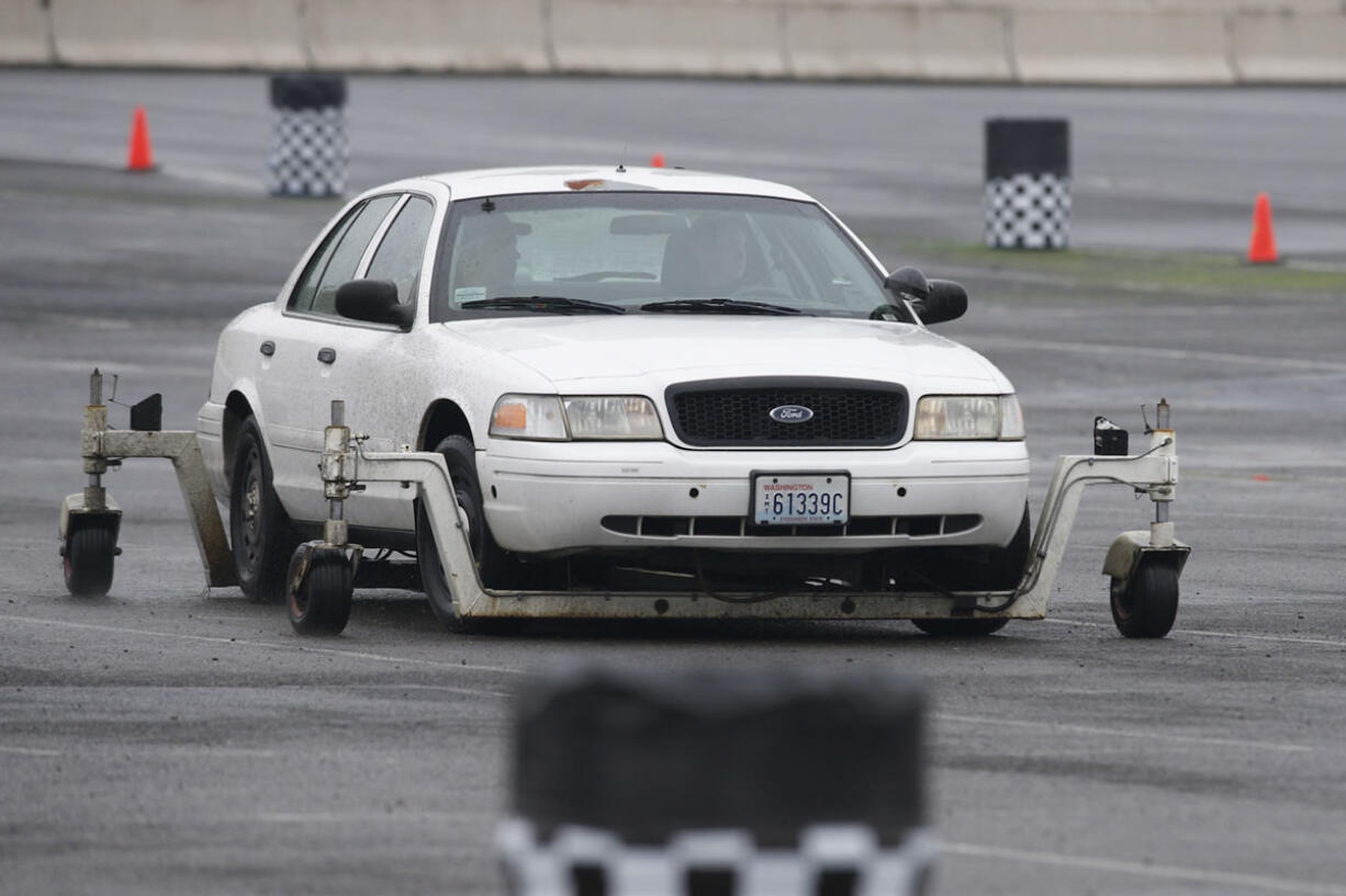 Officers use a skid-car system to simulate drifting and hydroplaning as part of annual driver training.